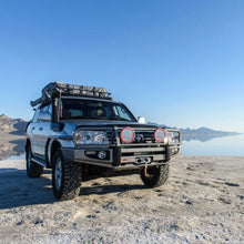 Load image into Gallery viewer, An OME 2 inch Lift Kit for LandCruiser 100 Series, Lexus LX470 (98-07) branded with Old Man Emu parked in the desert.