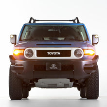 Load image into Gallery viewer, The front end of a blue Toyota FJ Cruiser equipped with the OME BP-51 2.5 - 3 inch Lift Kit for FJ Cruiser (10-ON) from Old Man Emu suspension and shock absorbers.