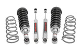 Suspension kit with four coil springs and four shock absorbers arranged on a white background