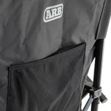 ARB Base Camp Chair 10500151 with heavy-duty steel frame, mesh rear storage pocket, and durable black fabric panel