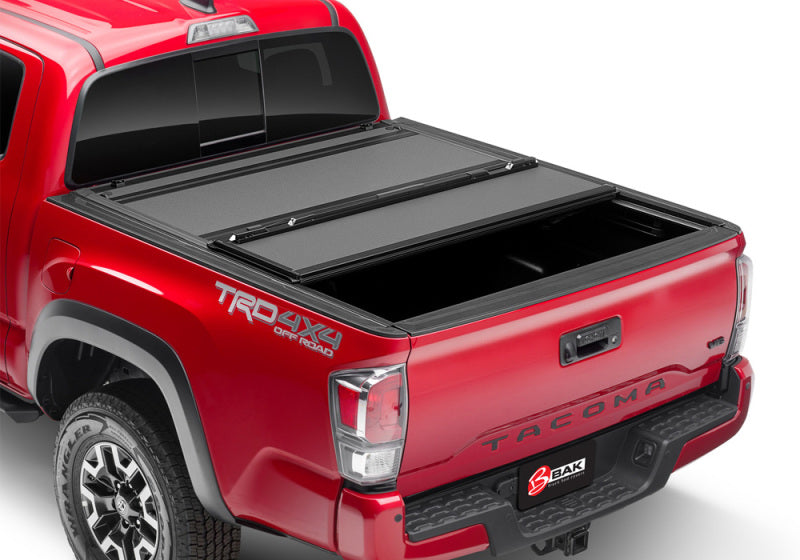 bak BAKFlip MX4 Hard Folding Tonneau Cover 448446 for Toyota Tacoma (24-ON) with textured black panels and reinforced hinges