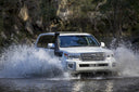 ARB Safari Armax Snorkel SS88HPE for Toyota Landcruiser 200 Series (prefacelift) V8 petrol engine installed on white vehicle crossing water
