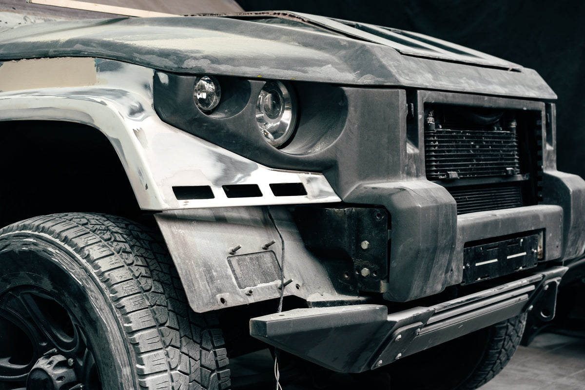 Off road truck front with heavy duty steel bumper grille and all terrain tire
