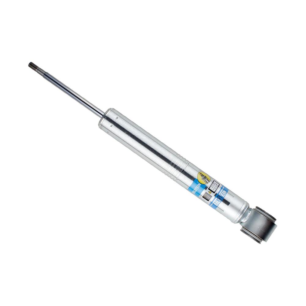 Silver suspension shock absorber with blue and yellow label and black mounting eye