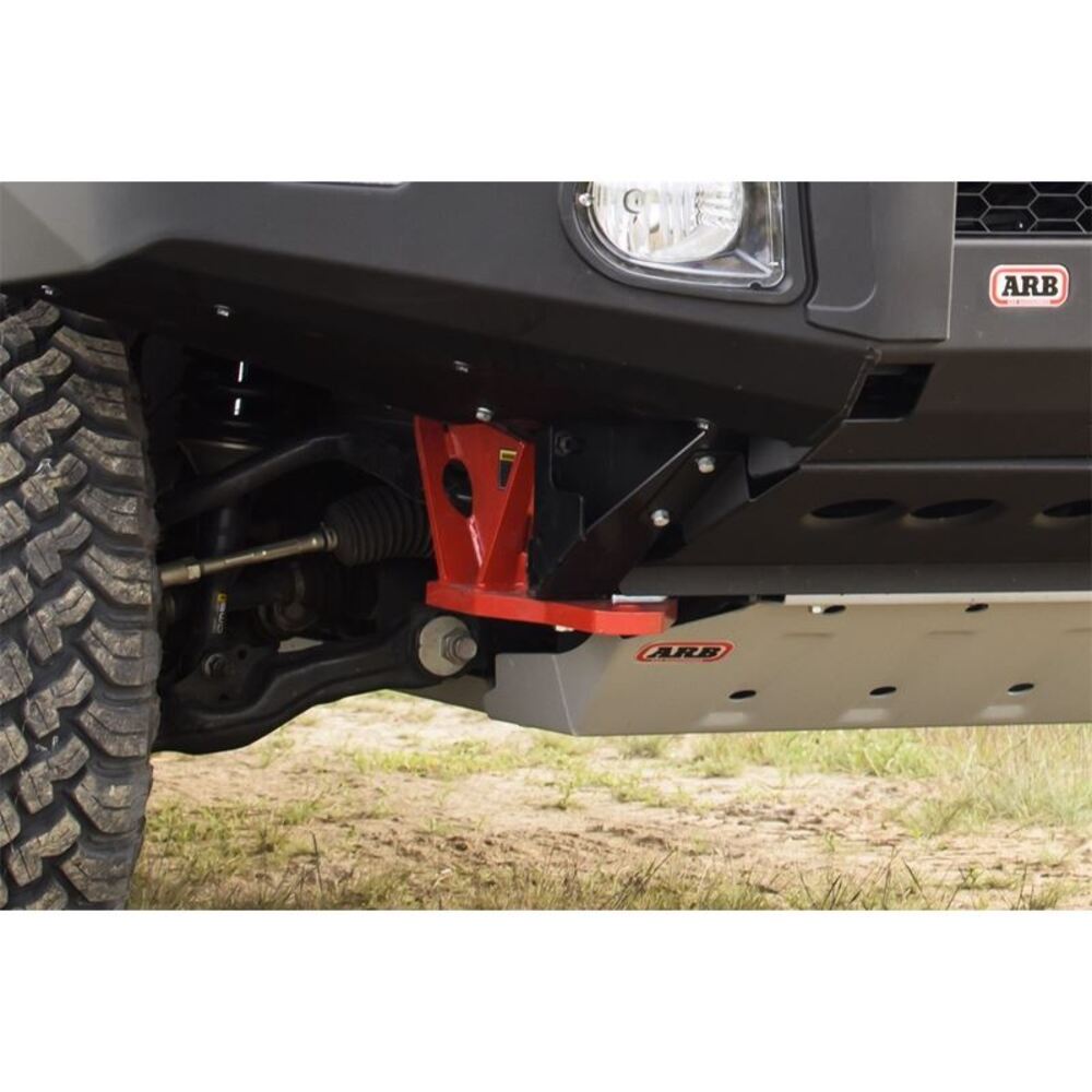 The front end of a truck with a red ARB bumper made of high grade steel.