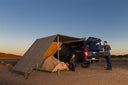 ARB Wind Break Front 1.25M 813301 heavy-duty front windbreak securing awning on off-road vehicle at campsite with tent, 4x4 context