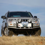 ARB Front Combination Bumper 3450130B for Jeep Grand Cherokee (1999-2007) - Fitting Kit Included with heavy-duty steel, black powder coat, and integrated light mounts
