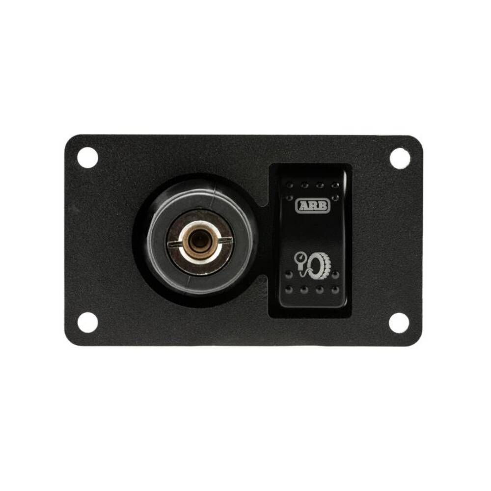 A black wall plate with a power outlet and an ARB Universal Switch Coupling Bracket. The ARB switch coupling bracket ensures convenience and easy control of the electrical connection.