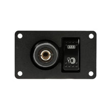 Load image into Gallery viewer, A black wall plate with a power outlet and an ARB Universal Switch Coupling Bracket. The ARB switch coupling bracket ensures convenience and easy control of the electrical connection.