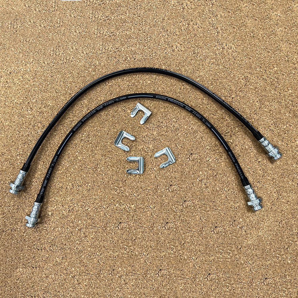 A pair of Mudify Front & Rear Brake Lines for Toyota 4Runner 2003 ON, FJ Cruiser 2007-ON, Lexus GX460 2010-ON hoses for brake lines on a wooden surface.