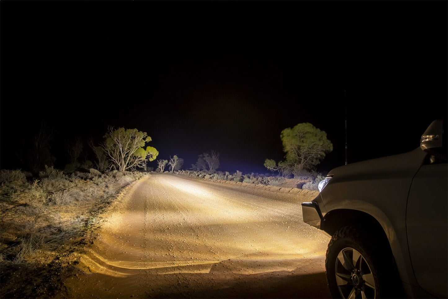 ARB Intensity V2 LED Spot Light AR21SV2 illuminating a rugged dirt road with high-performance OSRAM LEDs at night