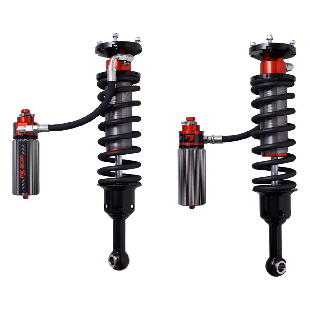 Pair of coilover suspension shocks with black springs and remote reservoirs on a white background