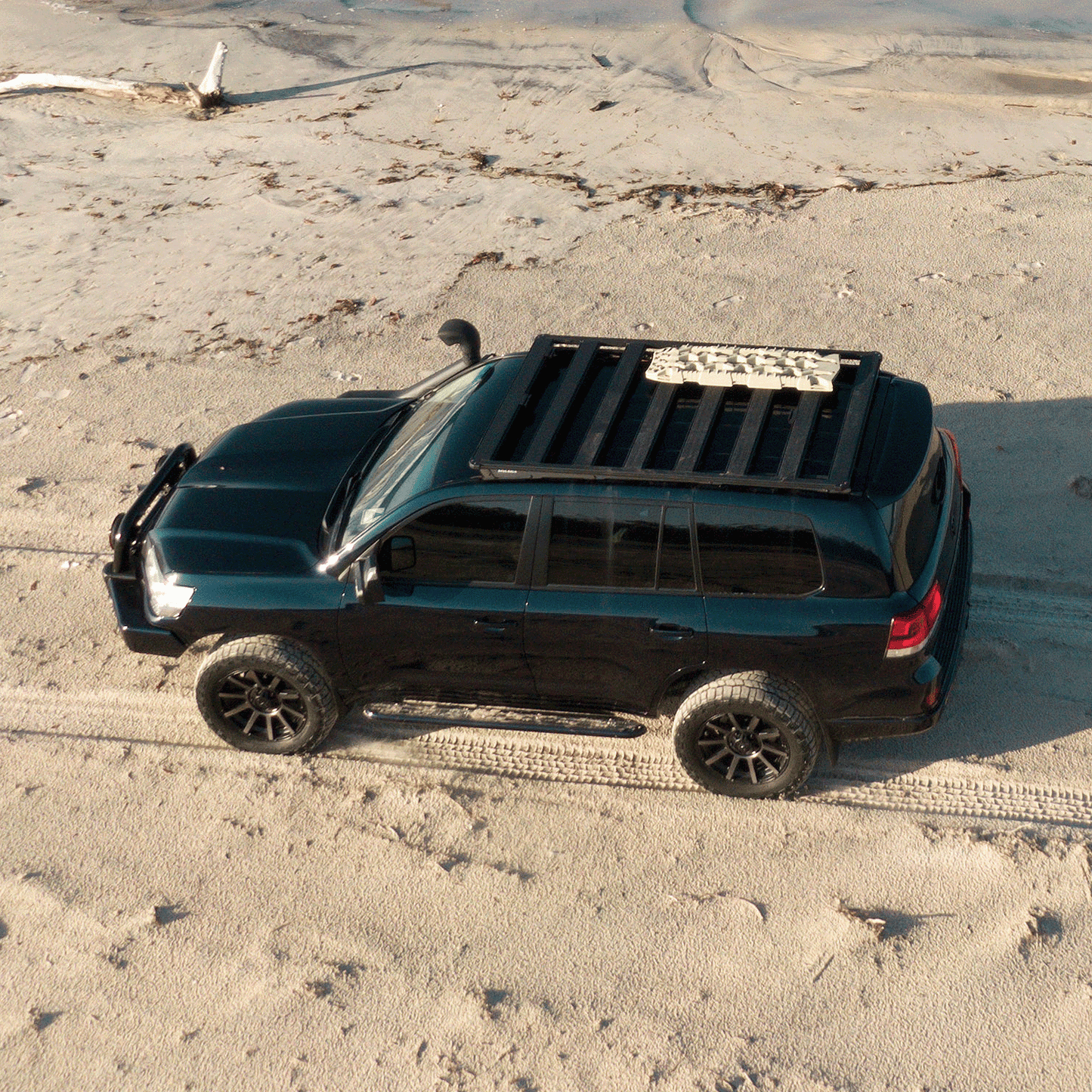 ARB TRED Pro Limited Edition Desert Sand Recovery Boards TREDPRODS mounted on roof rack of black off-road 4x4 SUV