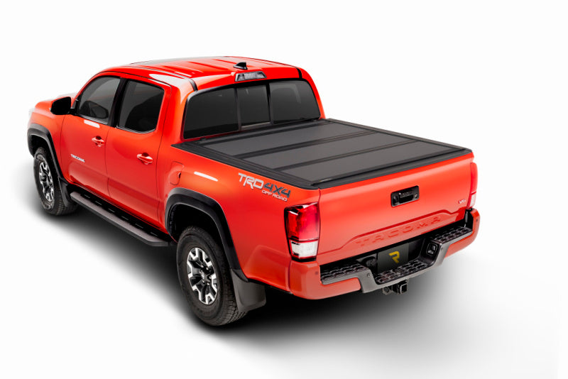 bak BAKFlip MX4 Hard Folding Tonneau Cover 448446 for Toyota Tacoma (24-ON) with textured black panels and reinforced hinges