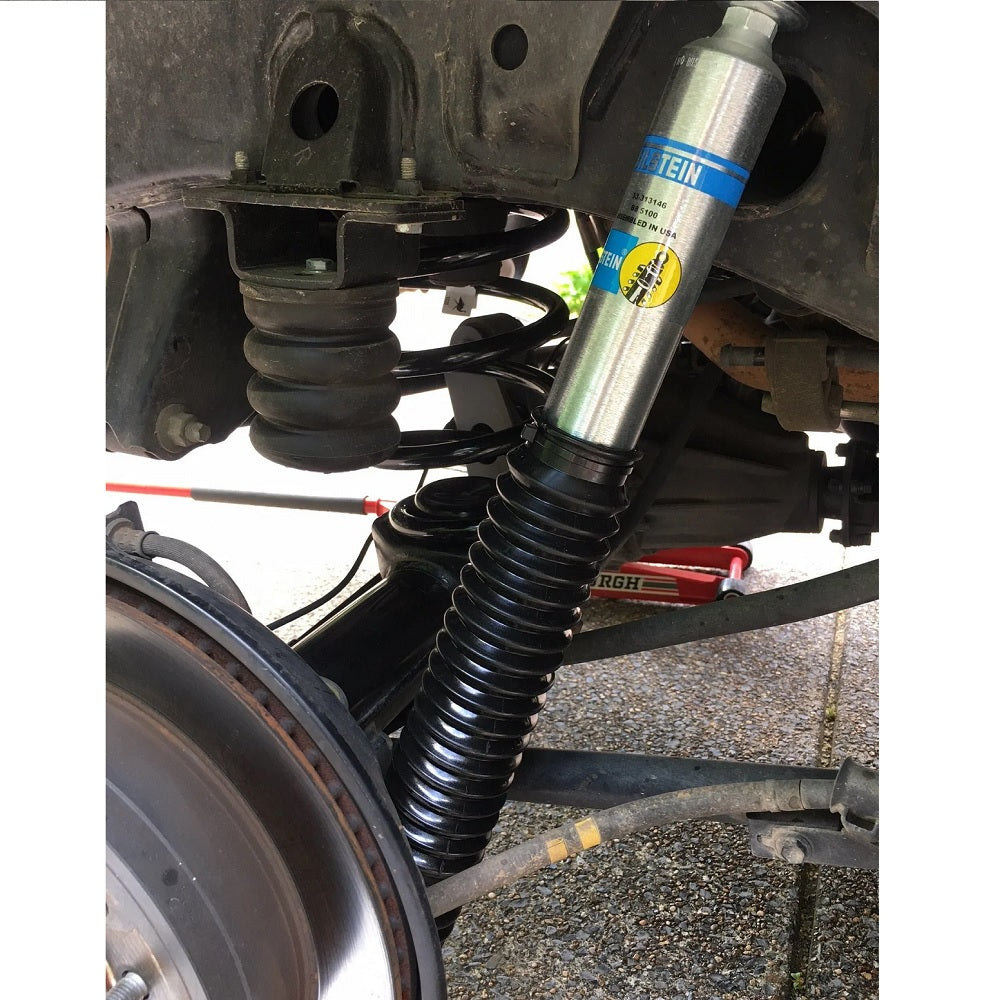 A Bilstein B8 5100 2 inch 4Runner (03-09) Lift Kit w/ OME Springs - Front Shocks Assembly, featuring Old Man Emu Springs, attached to it.