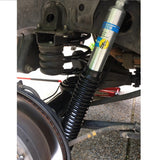 A Bilstein B8 5100 2 inch 4Runner (03-09) Lift Kit w/ OME Springs - Front Shocks Assembly, featuring Old Man Emu Springs, attached to it.