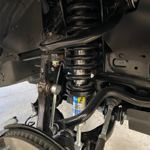 Load image into Gallery viewer, The rear suspension of a vehicle is shown with the Bilstein B8 5100 2.5 inch 4Runner (03-09) Lift Kit w/ OME Springs - Front Shocks Assembly provided by Bilstein.