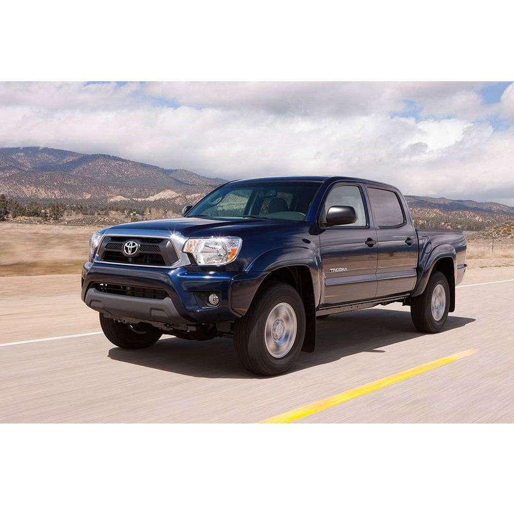 The blue Toyota Tacoma with a Bilstein B8 5100 0-2 inch Tacoma (05-15) Adjustable Leveling Kit is off-road experience driving down the road.