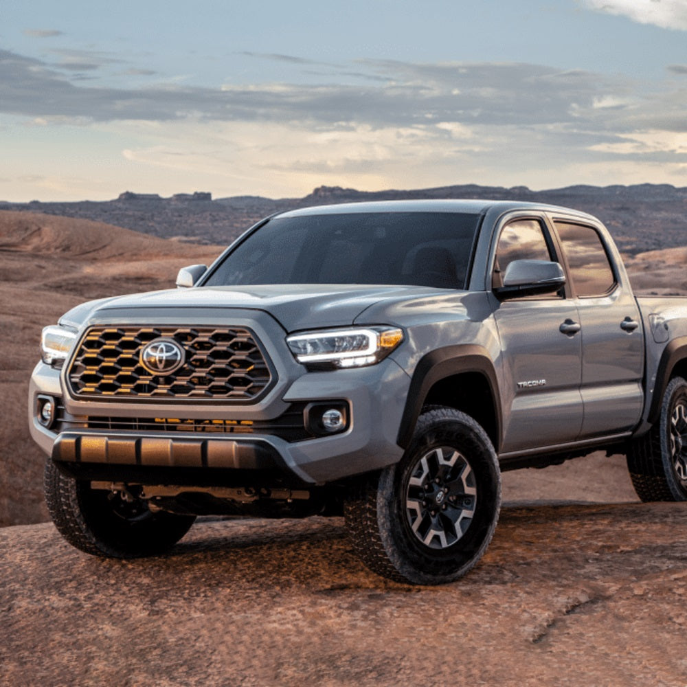 The 2020 Toyota Tacoma, equipped with the Bilstein B8 6112/5100 0-2 inch Tacoma (16-23) Lift Kit w/ OME Leaf Springs by Bilstein, is shown off-road in the desert.