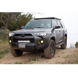 The Toyota 4Runner, equipped with the Bilstein B8 8112 2 inch 4Runner (10-ON) Lift Kit w/ OME Springs suspension system, is parked on a dirt road, showcasing its off-road performance capabilities.