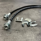 Durable Mudify brake lines facilitating axle movement on a concrete surface.
