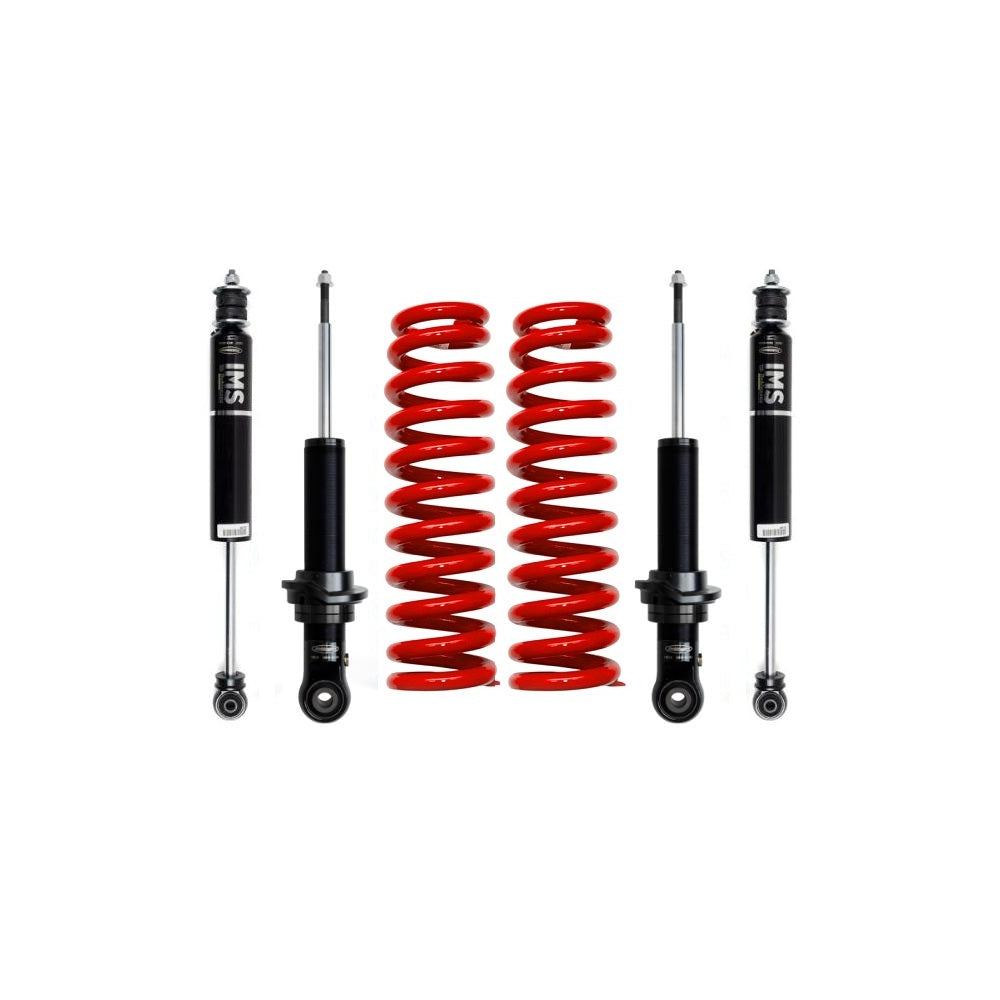 Four black shock absorbers and two red coil springs for vehicle suspension
