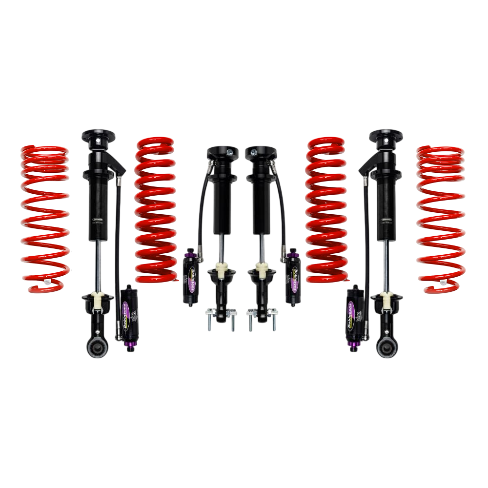 Off-road suspension lift kit with red coil springs and black shock absorbers laid out on a white background