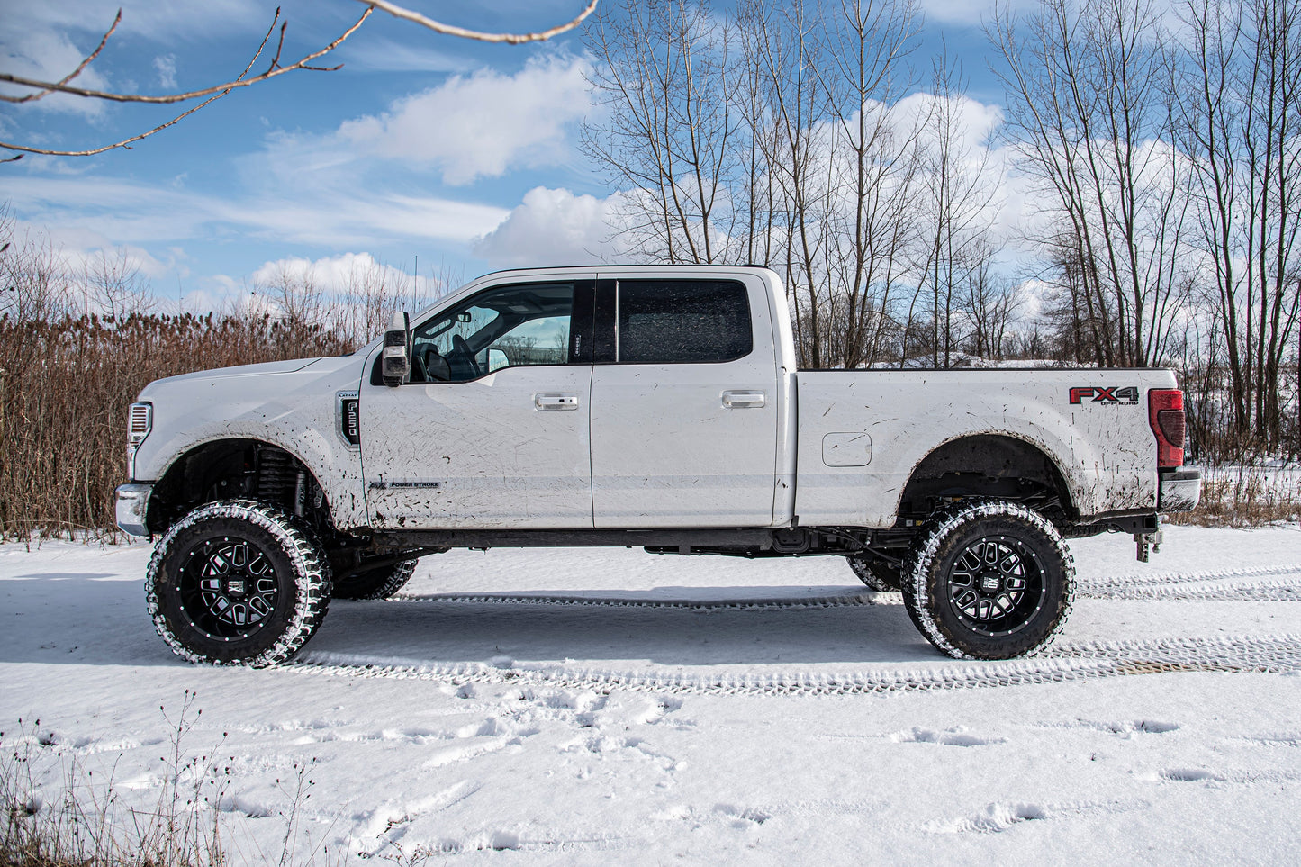 BDS 7 Inch Lift Kit w/ Radius Arm | Ford F250/F350 Super Duty (20-22) 4WD | Diesel with lifted suspension and off-road tires in snowy terrain