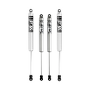 Four silver FOX off-road shock absorbers with black decals and eyelet mounts
