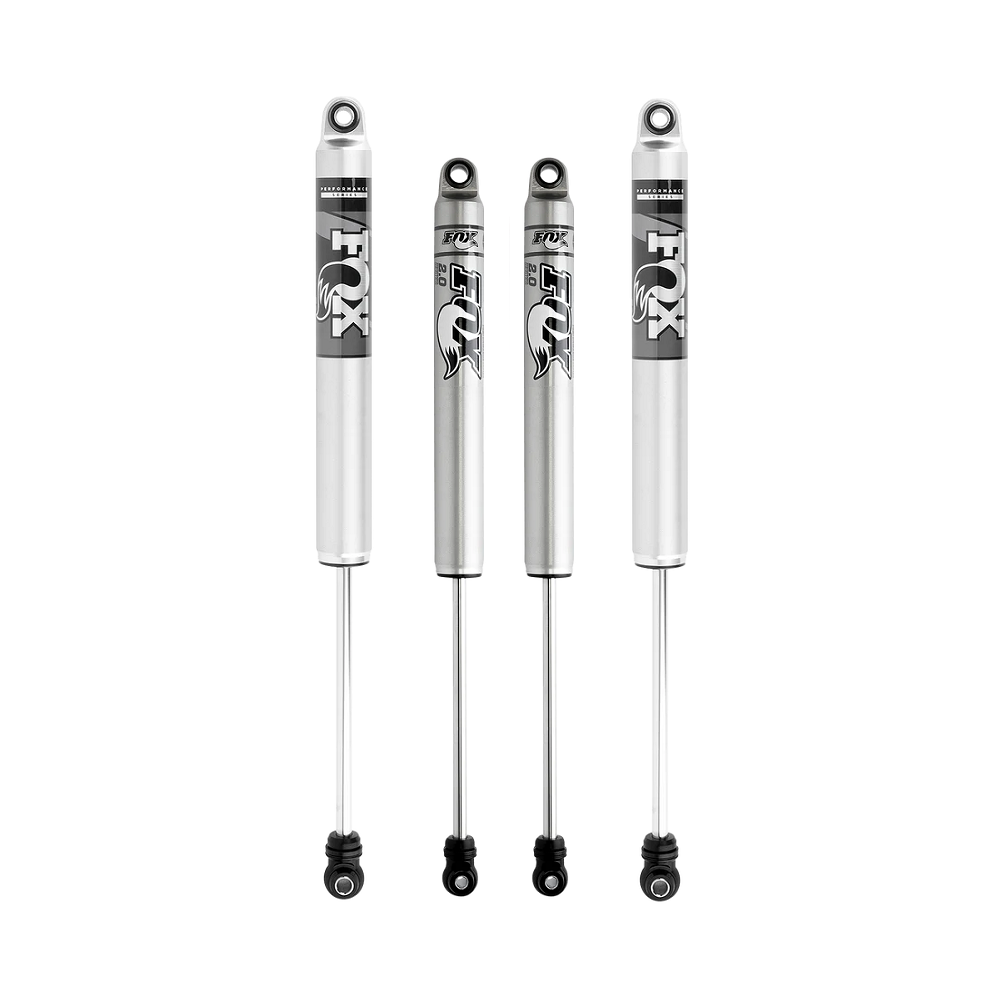 Four silver FOX off-road shock absorbers with black decals and eyelet mounts