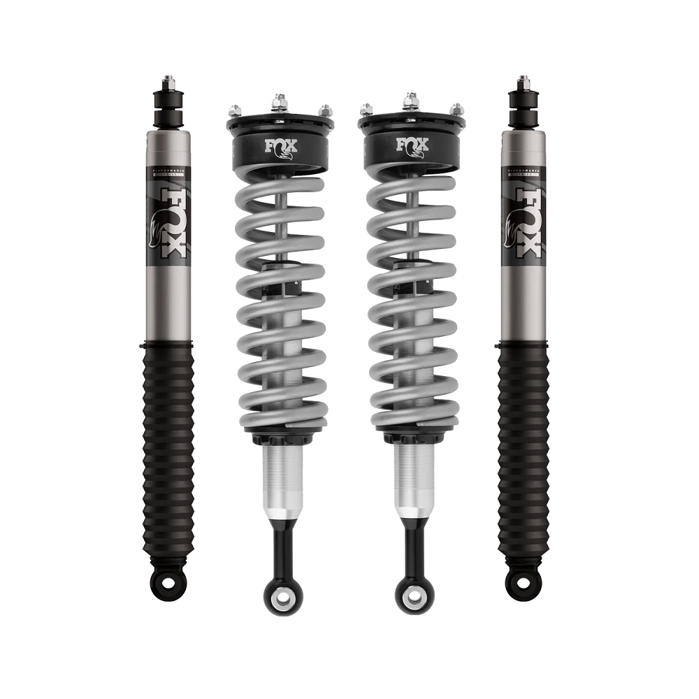 Fox suspension shocks and coilover springs arranged on a white background