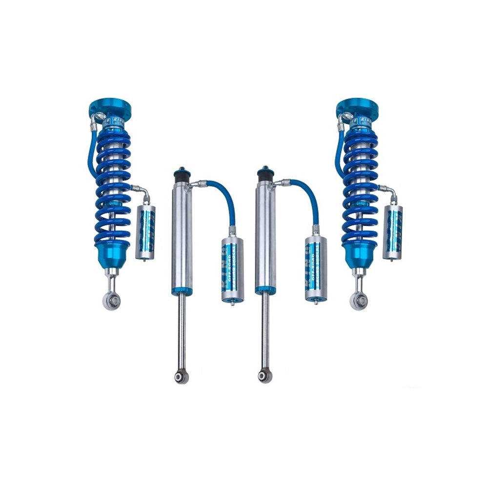 A set of blue King Shocks providing stability and off-road performance on a white background.