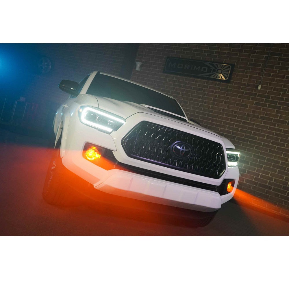Morimoto XB LED Type T Fog Lights for Toyota 4Runner (2010-2023) with amber LED fog lamps in urban setting