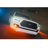 Morimoto XB LED Type T Fog Lights for Toyota 4Runner (2010-2023) with amber LED fog lamps in urban setting