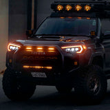 A black Toyota 4Runner with Morimoto XB Led Headlights for Toyota 4Runner (2014-2023) is parked at night.