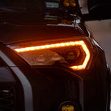 A close up of the headlights of a black SUV featuring Morimoto XB Led Headlights for Toyota 4Runner (2014-2023).
