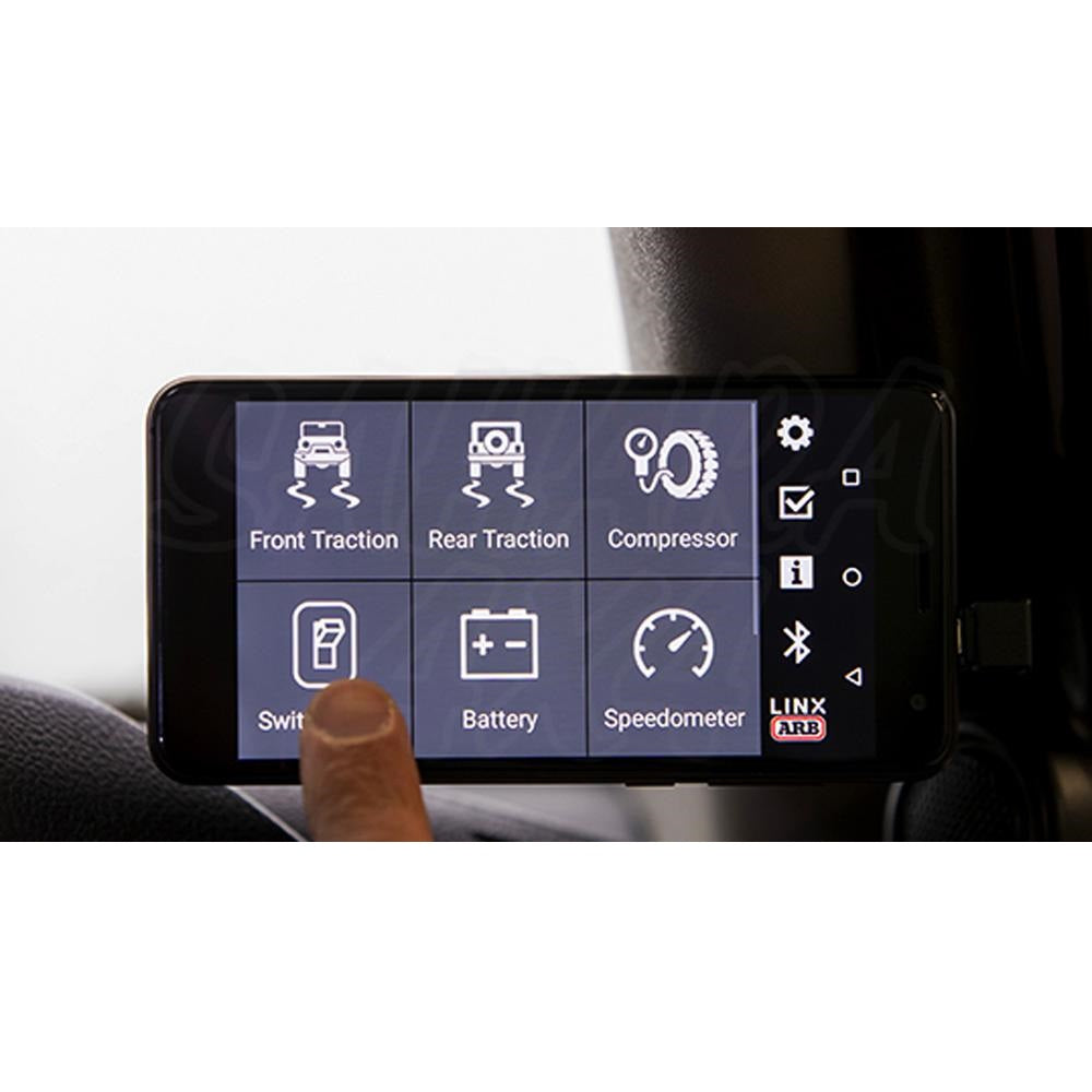 A person using a smart phone mounted on an ARB LINX Vehicle Accessory Interface LX100 mount in a car.