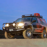 A Toyota 4Runner, equipped with an Old Man Emu OME 2 inch Lift Kit for 4Runner (03-09) suspension system and Nitrocharger shocks, is parked on a dirt road with ample ground clearance.