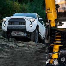 Load image into Gallery viewer, An Old Man Emu OME 2.5 inch Lift Kit for 4Runner (10-23) equipped Toyota Tacoma with an enhanced suspension articulation is tackling a rocky trail.