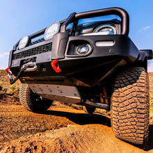 Load image into Gallery viewer, A black jeep with an OME 3 inch Lift Kit for Bronco Base, Big Bend, Outer Banks, Wildtrack (21-ON) by Old Man Emu is driving down a dirt road, equipped with Nitrocharger shocks for increased ground clearance.