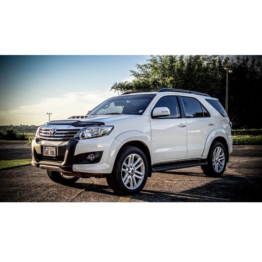 A white Toyota Fortuner parked on the road, showcasing its enhanced ride quality with the Old Man Emu 2.5 inch Lift Kit for Fortuner (05-14) and Nitrocharger shocks.