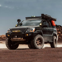 Load image into Gallery viewer, An Old Man Emu-modified Lexus GX470 (03-09) is parked in the desert, showcasing its impressive OME 2.5 inch Lift Kit suspension system and ground clearance.