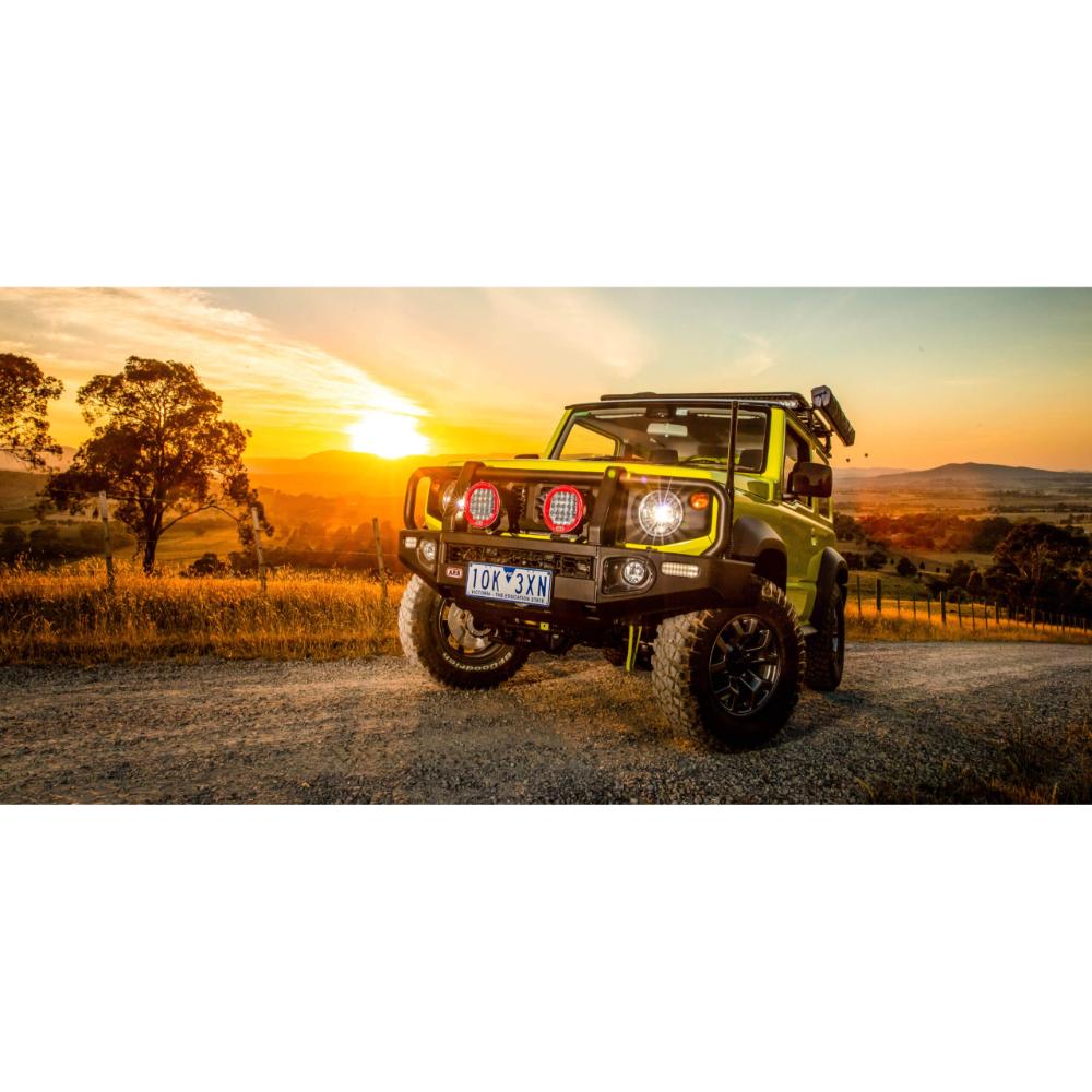 Old Man Emu Nitro+ 2.5 inch Lift Kit for Suzuki Jimny (18-ON) on lifted green Jimny with off-road tires and suspension components