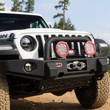 Load image into Gallery viewer, The front bumper of a Jeep Wrangler with an OME 2 inch Lift Kit for Jeep Wrangler JL 4 Door (18-23) by Old Man Emu, providing remarkable ground clearance.