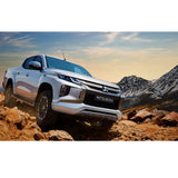 The 2019 Mitsubishi Triton, equipped with the Old Man Emu Prado suspension system, effortlessly tackles a rocky road with its Nitrocharger shocks and increased ground clearance.