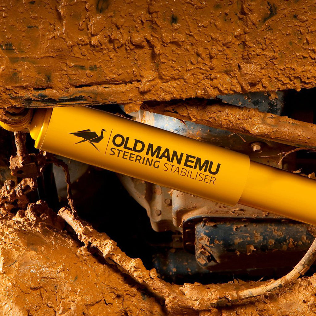 A yellow hose sticking out of a piece of dirt, showcasing enhanced suspension articulation with the OME 4 inch Lift Kit for LandCruiser 80 & 105 Series (90-07) from Old Man Emu.