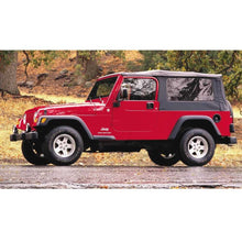 Load image into Gallery viewer, A red Old Man Emu jeep with the OME 2 inch Lift Kit for Wrangler LJ / TJ Unlimited (03-06) is parked in the rain.