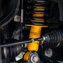 Load image into Gallery viewer, A vehicle with a yellow shock absorber and an Old Man Emu OME 2 inch Lift Kit for NP300 (19-ON) suspension system attached to it.