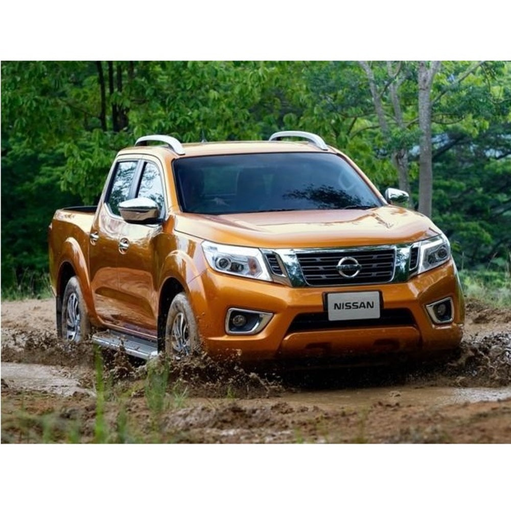 The orange Nissan Navara, equipped with the OME 2 inch Lift Kit for NP300 (19-ON) from Old Man Emu, confidently maneuvers through the mud.