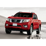 The red Nissan Frontier, equipped with the OME 2 inch Lift Kit for NP300 (19-ON) from Old Man Emu, is parked on the beach.